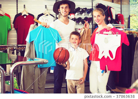 Adult positive parents with boy in sport store Adult positive parents with boy in sport store 37863638
