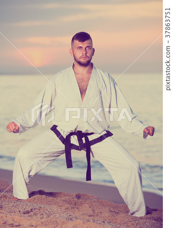 Nice man doing karate at ocean quay 37863751