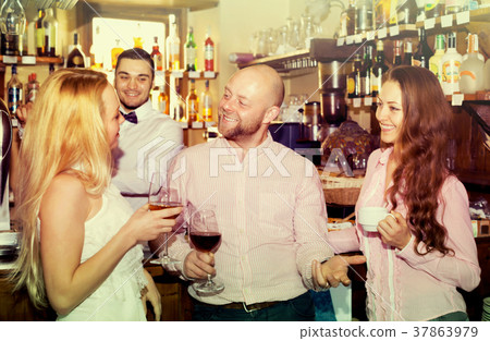 Friends at bar with barman 37863979