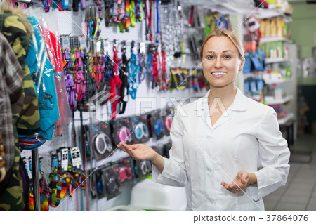 Smiling girl seller work with leashes for pets 37864076