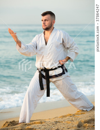 Active male practising karate kata poses Active male practising karate kata poses 37864247