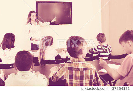 Little children with teacher in classroom 37864321