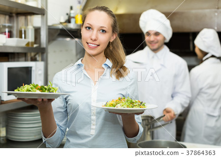 Waitress with plates at kitchen 37864363