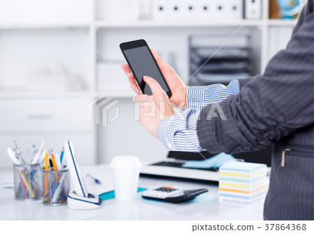 Hands of businesswoman using phone Hands of businesswoman using phone 37864368