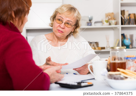 Serious old women with public utilities Serious old women with public utilities 37864375