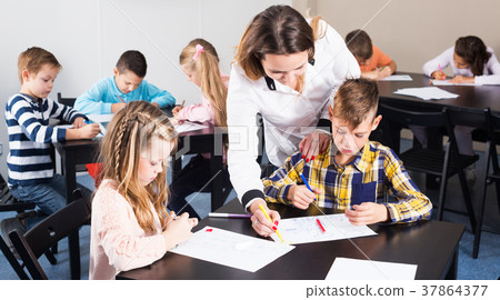 Boys and girls with teacher drawing Boys and girls with teacher drawing 37864377