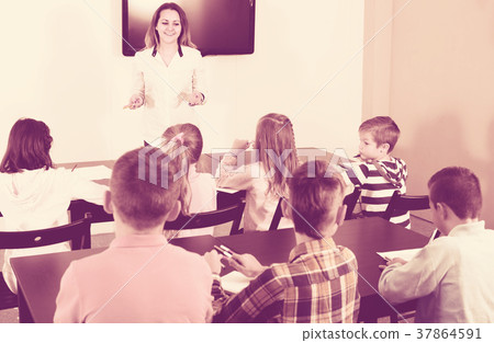 children with teacher in classroom 37864591