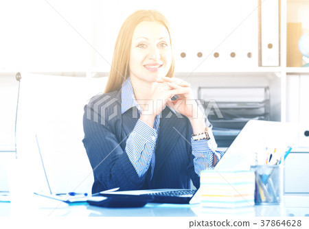 Cheerful businesswoman at workplace Cheerful businesswoman at workplace 37864628