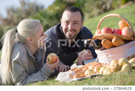 adults with apples in nature 37864629