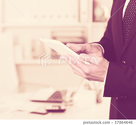 Hands of businessman using smartphone Hands of businessman using smartphone 37864646