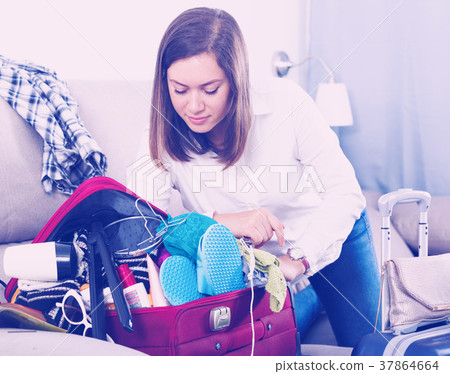 Woman packing for holiday 37864664