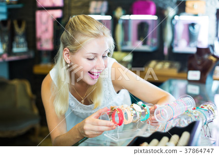 Woman buying bracelet in store 37864747