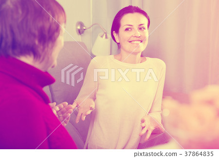 Mature woman and daughter talking at sofa 37864835
