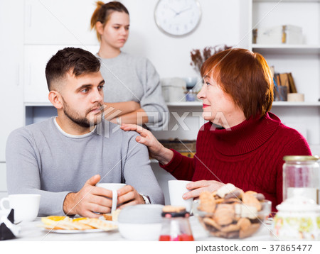 Mother comforting son after discord with wife 37865477