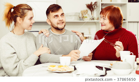 Cheerful family with papers 37865650