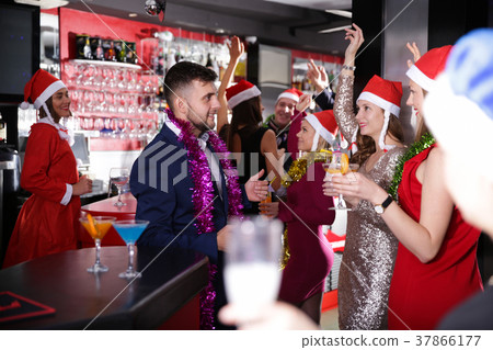 Man with females on corporate new year party in bar 37866177