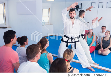 Karate coach teaching adults 37866519