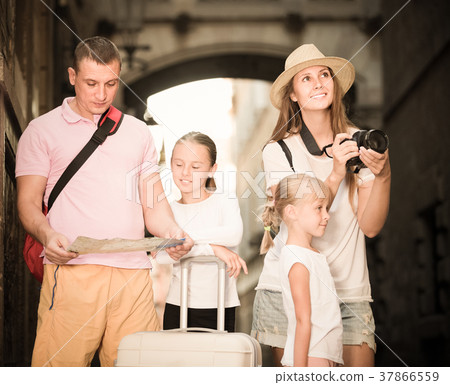 Positive family with children using map and photographing 37866559