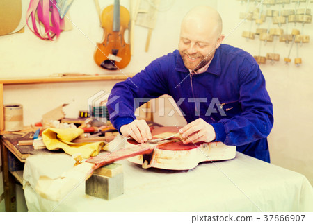 Guitar-maker at workshop. 37866907