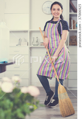 Cheerful girl sweeping floor Cheerful girl sweeping floor 37866925