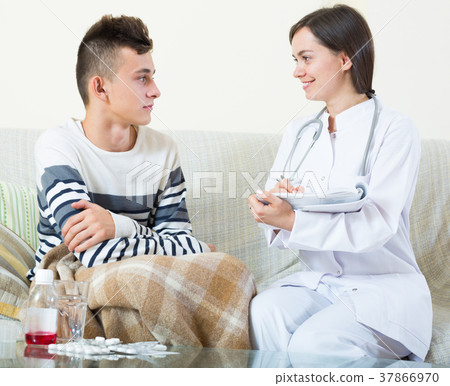 Doctor examinating teen boy with quinsy at home Doctor examinating teen boy with quinsy at home 37866970