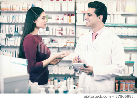 pharmacist serving woman in pharmacy pharmacist serving woman in pharmacy 37866995