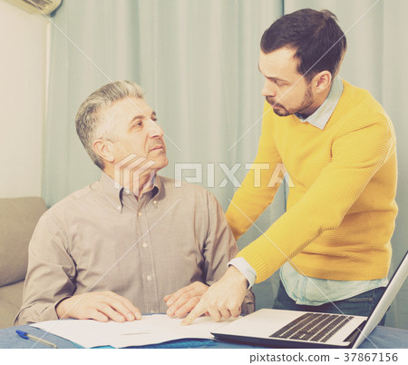 Adult father and son discuss contract Adult father and son discuss contract 37867156