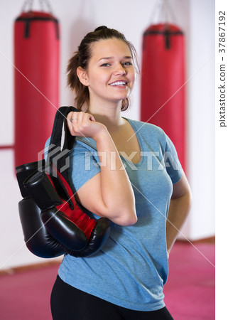 Young girl with gloves in the boxing hall Young girl with gloves in the boxing hall 37867192