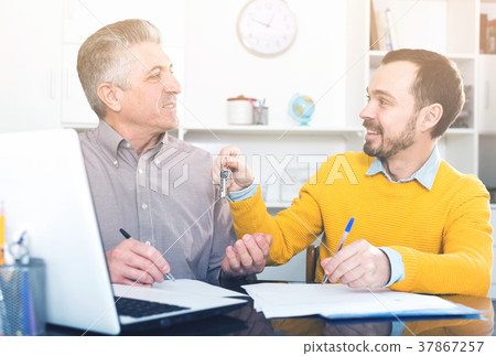 Mature man and agent sign rental agreement 37867257