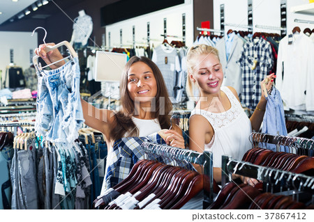 Women choosing jeans shorts Women choosing jeans shorts 37867412