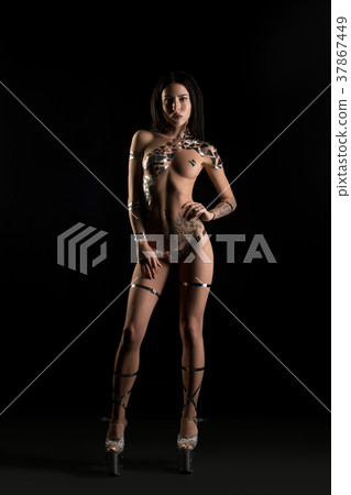 Naked brunette with gold body art in high heels 37867449