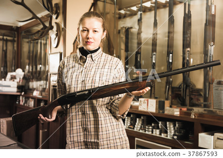 Positive female in hunting shop with rifle Positive female in hunting shop with rifle 37867593