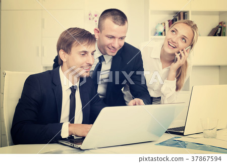 Business colleagues working and discussing on phone Business colleagues working and discussing on phone 37867594