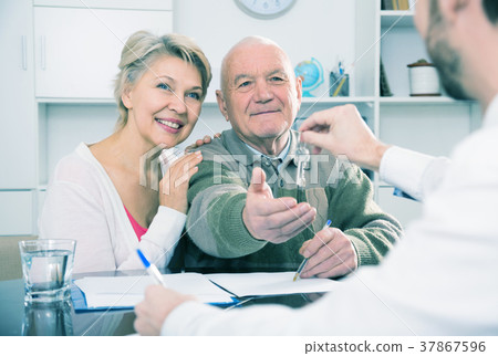 Couple buying house in bank Couple buying house in bank 37867596
