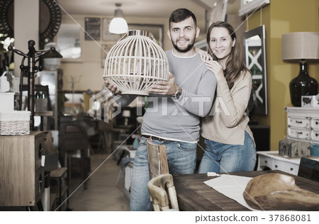 Girl with boyfriend in search of lampshade 37868081