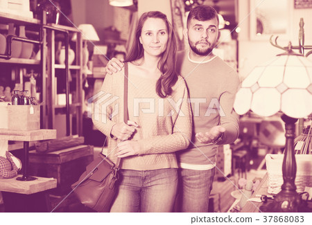 Loving couple in shop of secondhand furniture 37868083