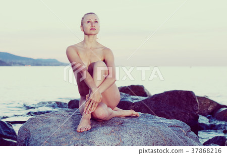 portrait of relaxation naked woman at ocean quay portrait of relaxation naked woman at ocean quay 37868216