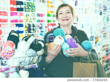 Woman holding shopping bags and accessories for knitting and embroidery Woman holding shopping bags and accessories for knitting and embroidery 37868264