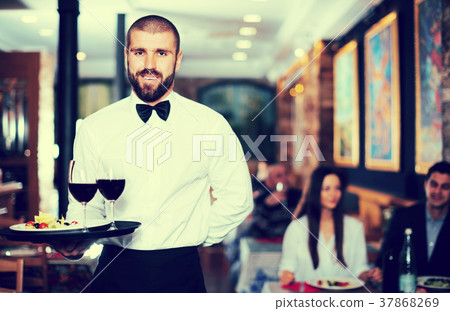 Waiter posing in restaurant Waiter posing in restaurant 37868269