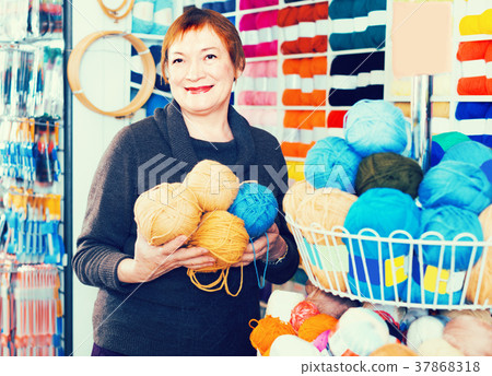 Female is choosing yarn for knitting at special price Female is choosing yarn for knitting at special price 37868318