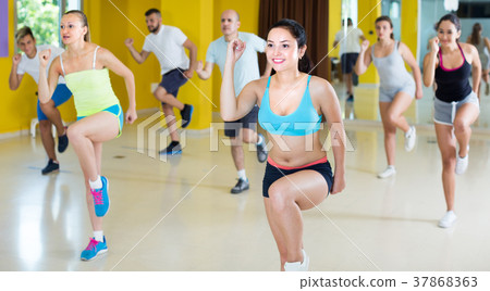 Women and men are dancing aerobics 37868363