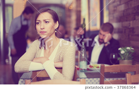 quarreled visitors female and male in restaurant 37868364