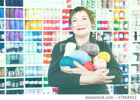 Mature female with colorful yarn for their hobby 37868422