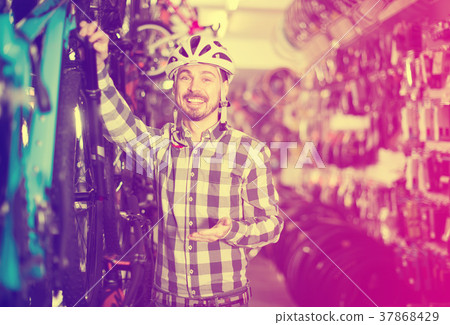 Man in helmet choose bike Man in helmet choose bike 37868429