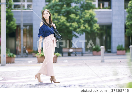 A woman walking in the city 37868746