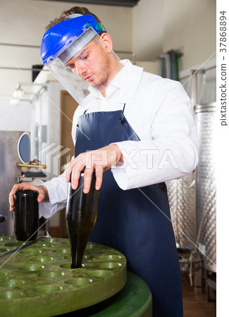 worker using machine at wine factory 37868894