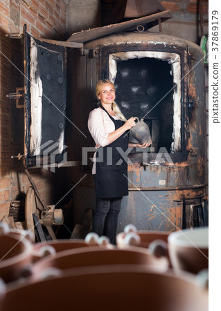 Potter holding black glazed ceramic 37869179