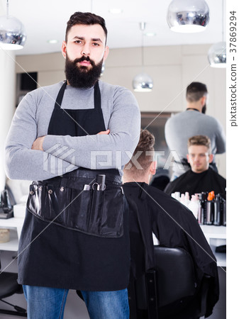 male hairdresser showing his workplace and tools at hair salon male hairdresser showing his workplace and tools at hair salon 37869294