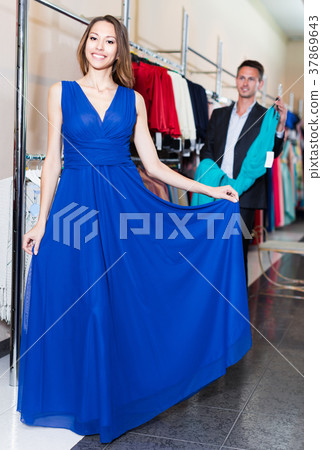 Young woman is trying on new dark blue dress Young woman is trying on new dark blue dress 37869643