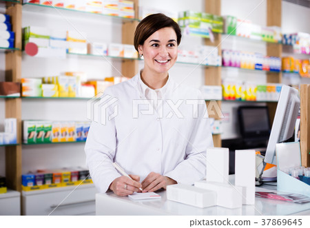 female pharmacist checking assortment of drugs in pharmacy female pharmacist checking assortment of drugs in pharmacy 37869645